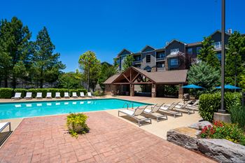 Outdoor pool with tanning shelf